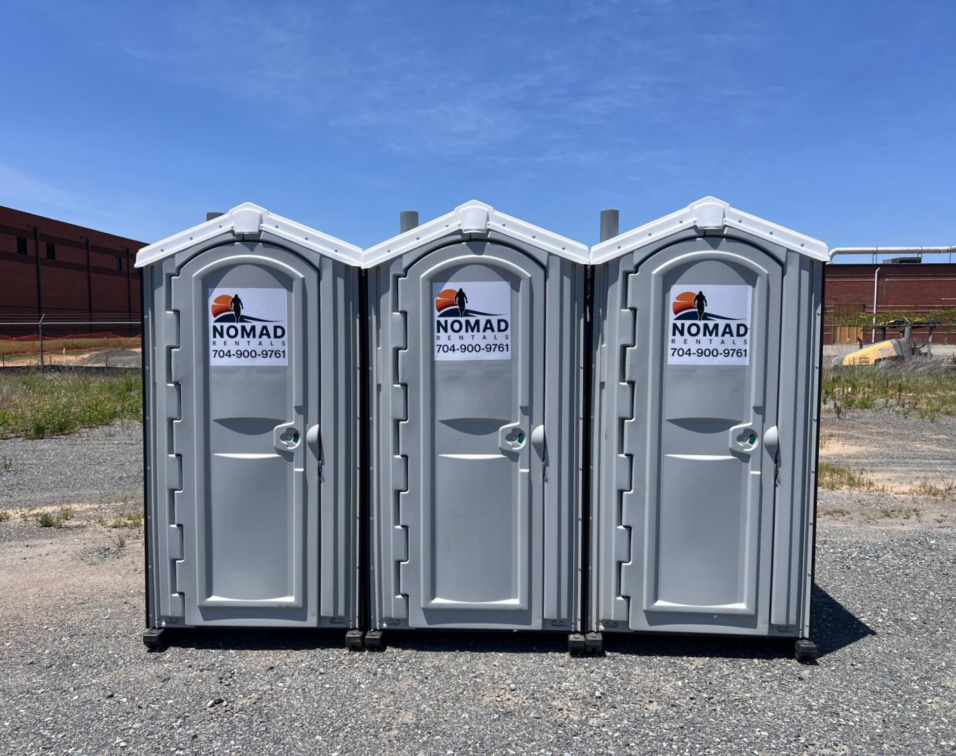 Portable restroom units arranged on grass in Mecklenburg County
